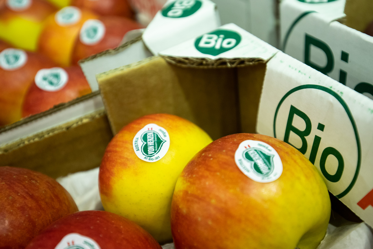 Organic apples of the Topaz variety in crates at a stand during the organic trade fair Biofach