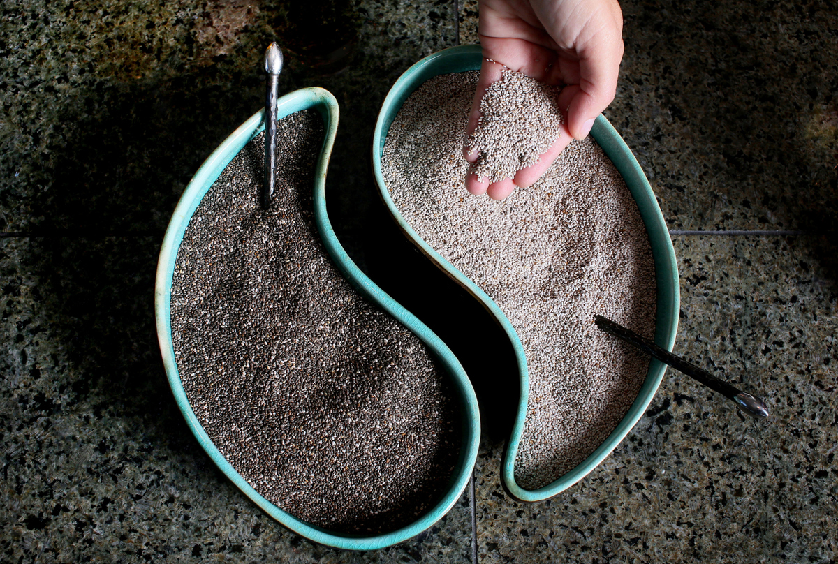 Black and White Chia seeds sit in ying-yang shaped dishes