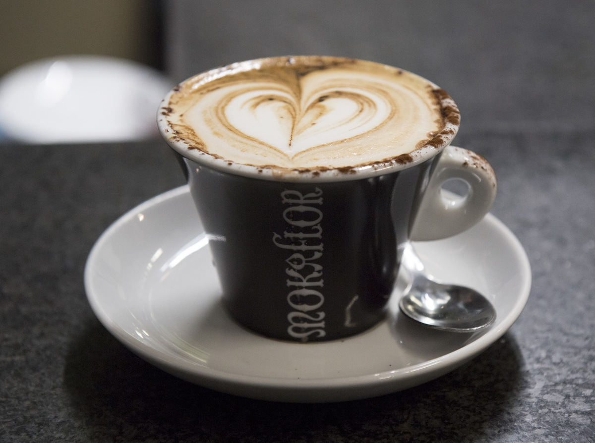 A coffee with foam in the shape of a heart