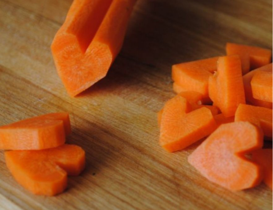 chopping carrots into heart shapes
