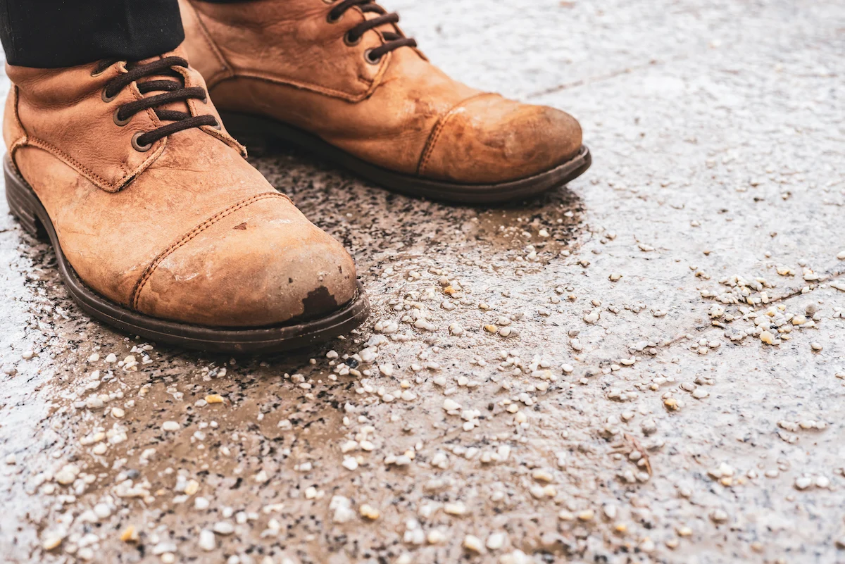 brown leather shoes in the rain and salt