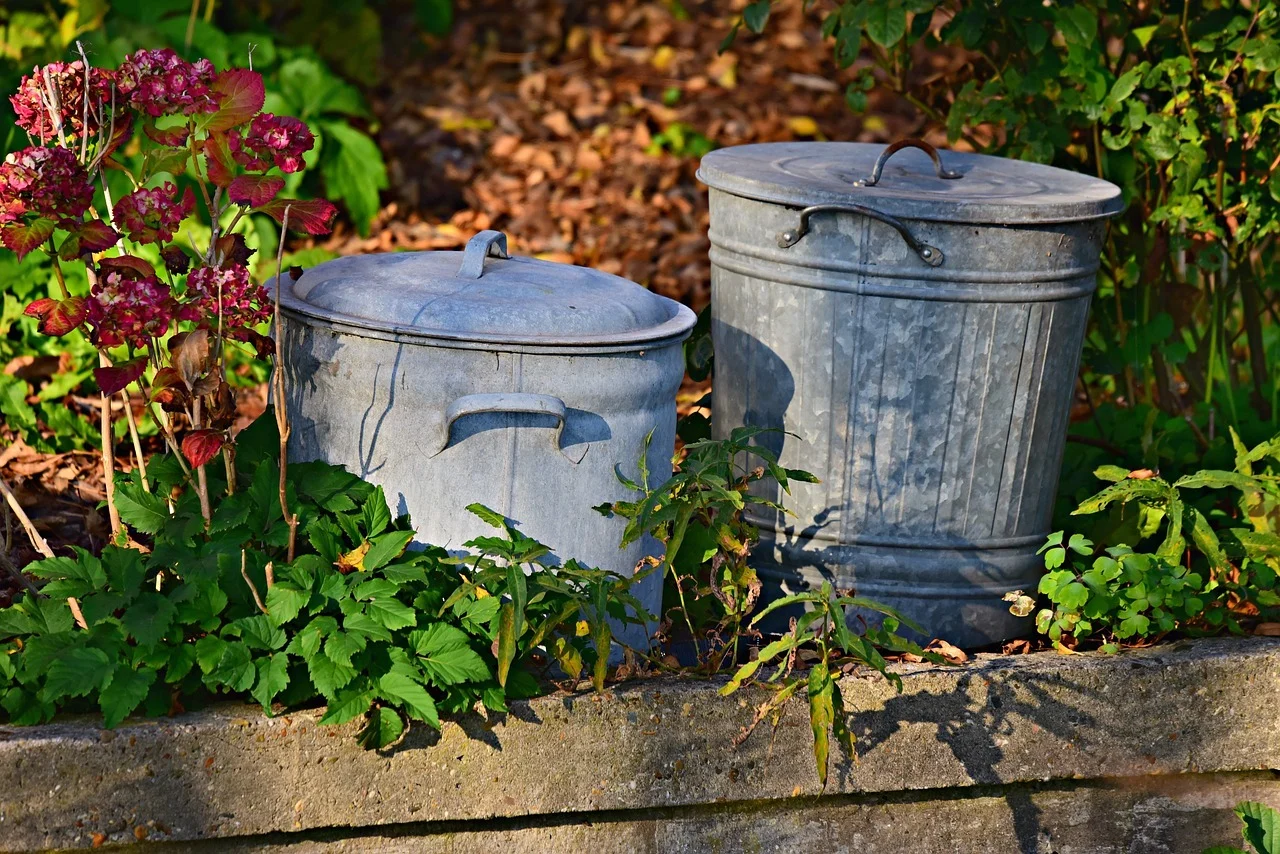 2 trash cans in the garden