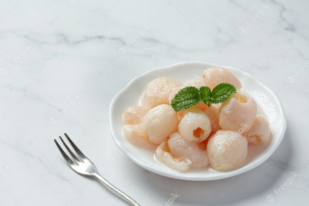 Free Photo | Lychee in syrup on white surface